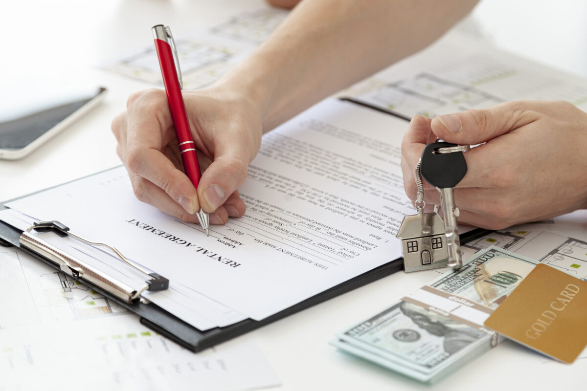 Firma de contrato de alquiler con llaves y dinero, asesoramiento inmobiliario seguro y profesional